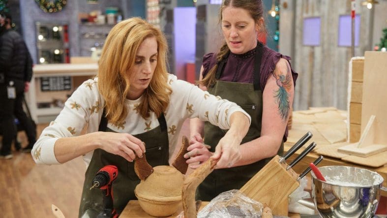 Two women crafting in a workshop setting.